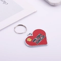 Detail of a red heart-shaped pet ID tag with gold paw print and Mejor Amigo text - Red Heart