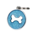 Macro view of round blue glitter pet ID tag with silver bone emblem and metal ring - Blue Gold