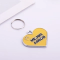 Detail of heart-shaped yellow enamel pet tag with Mejor Amigo text and paw print - Yellow Heart
