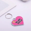 Detailed close-up of a pink heart-shaped pet ID tag with engraved Mejor Amigo lettering - Pink Heart