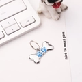 Polished bone-shaped metal dog tag with blue paw prints and connecting ring for collars - 30*15mm / Blue