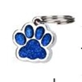 Detailed close-up of a blue glitter paw print dog ID tag with a silver zinc alloy frame - Dark Blue