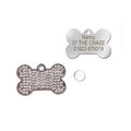 Detailed view of bone-shaped pet ID tags featuring rhinestone inlay and custom engraving - White