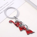 Creative keychain featuring three red enamel dinosaur charms on a polished silver metal ring - Red Brachiosaurus