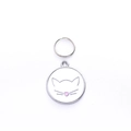 Detailed view of white metal cat ID tag with pink heart nose and ring attachment - 25mm / White