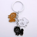 Detailed macro view of three enamel chow chow dog charms in brown, white, and black colors - 12cm / Multicolor String