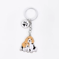 Close-up of enamel Beagle dog keychain with paw charm in silver finish metal - Basset Hound Friends + Paw Print