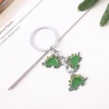 Cute green dinosaur keychain with three stegosaurus charms in polished zinc alloy metal - Three Green Stegosaurus (Green String) / Green Dinosaur String