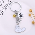 Llavero de gato persa blanco metálico con dije de pata y cascabeles de colores - Gato Persa