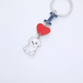 Macro detail of enamel I Love Dog keychain with heart and white puppy charm - Bichon Frise