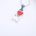 Detail of keychain featuring white Samoyed dog, red heart, and blue letter enamel charms - Samoyed