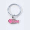 Artistic silver fish bone keychain with pink enamel inlay on white background - Pink