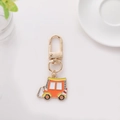 Close-up of a cartoon engineering vehicle keychain with gold metal lobster clasp - Rickshaw