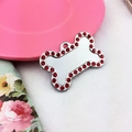 Detailed macro view of bone shaped pet tag with red rhinestones and engraving space - 34 Rhinestones Red