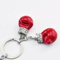 Detail of red enamel boxing glove keychain with white rhinestone crystal accents - 10cm / Silver Red