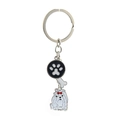 Close-up of metal pet keychain with dog paw charm, white bone, and cute dog detail - Maltese