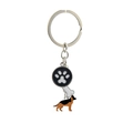 Detail of metal keychain featuring enamel German Shepherd, paw print, and bone charms - German Shepherd