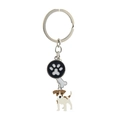 Detail of metal keychain with Jack Russell terrier, paw print and bone charms - Jack Skellington