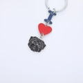 Metal Pug dog keychain with blue letter I and red heart charm on white background - Black Pug