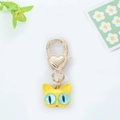 Detailed close-up of a golden cat keychain with blue eyes and heart shaped lobster clasp - Big Eye Cat Yellow