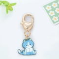 Detail of blue and white cat enamel pendant with golden heart-shaped lobster clasp hook - Light Blue