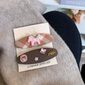Pink checkered horse hair clip and brown rhinestone hairpin set on a card display - Pink Plaid Style