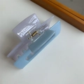 Detail shot of a two-tone lavender and light blue acrylic hair claw with a gold spring - Blue and Light Gray Color Block