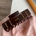Detailed close-up of brown hair claw clip with rhinestones and gold lettering on fabric - Brown Rectangular Rhinestone Claw Clip