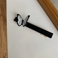 Close-up of a minimalist black and white butterfly hair clip with gold metal spring - Black Single Butterfly Hair Clip