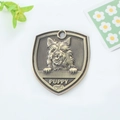 Bronze shield-shaped pet ID tag with puppy relief and engraved bone icon for collars - Cairn Terrier Style (160)