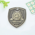 Vintage bronze shield dog tag with carved puppy relief and bone pattern ornament - Samoyed (148)