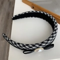 Close-up of houndstooth headband with satin bow and gold-edged pearl detail - Black Plaid