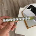 Detail of olive green resin hair clip featuring nine elegant white faux pearls - Spring Clips / Green Rectangular