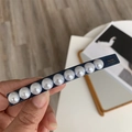 Detailed view of long navy hair clip with ten white pearls and gold La France lettering - Spring Clips / Blue Rectangle
