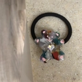 Close-up of cute cartoon bear hair tie with heart-shaped crystal and elastic rope - Multicolor Bear