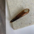 Close-up of tortoise shell pattern acrylic hair clip with smooth waterdrop design - Caramel