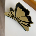 Détail de la pince à cheveux papillon en acétate noir et or avec des strass étincelants - Papillon Vert Vintage Noir