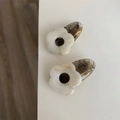Close-up of marble pattern resin flower hair clips with vintage dark teardrop base - Gray