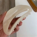 Detail of handmade cream acetate crescent hair claw showing gold France engraving - Light Beige