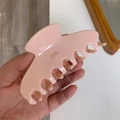 Close-up of pink acetate hair claw with gold Barrette la France lettering detail - Light Pink