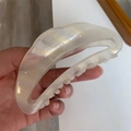 Detail of white acetate crescent hair claw featuring France Handmade engraving inside - Lightning White