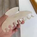 Detail showing cream-colored resin hair claw clip with Barrette La France lettering - Light Beige