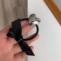 Close-up of black elastic hair tie with silver heart metal and Lucky printed bow - Large Heart Hair Tie