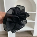 Detail of multi-layered black organza hair scrunchie with ruffled edges and sheer texture - Black