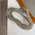 Detail of marble pattern acetate claw clip with irregular hollow design and gold logo - Gray Marble Texture