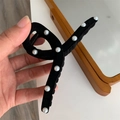 Dettaglio di un grande fermaglio per capelli in velluto nero con perle bianche lucide - Pinza per Capelli in Floccato Perle / Nero