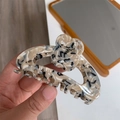 Detailed macro view of acetate flower hair claw clip with marble texture and glossy finish - Black Beige Texture Style (F2-042)