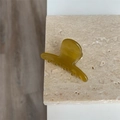 Detail showing the inner France engraving on a translucent amber resin hair clip - Yellow-Green