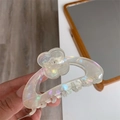 Detailed view of iridescent flower hair claw clip with laser finish and Amber Bear logo - Pearlescent White Flower Style (F2-042)
