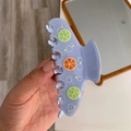 Detailed close-up of fruit-themed hair claw clip with lemon pattern and rhinestones - Light Blue